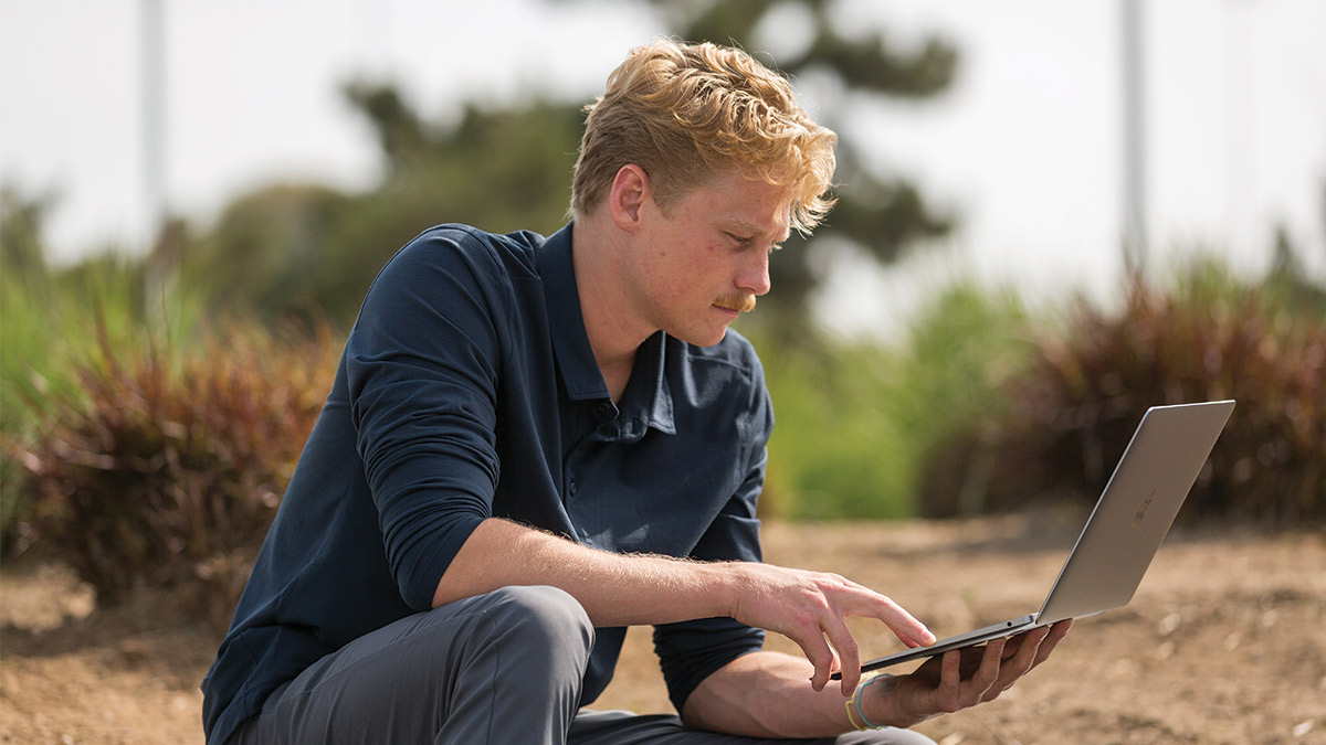 LMU Student looking at a laptop