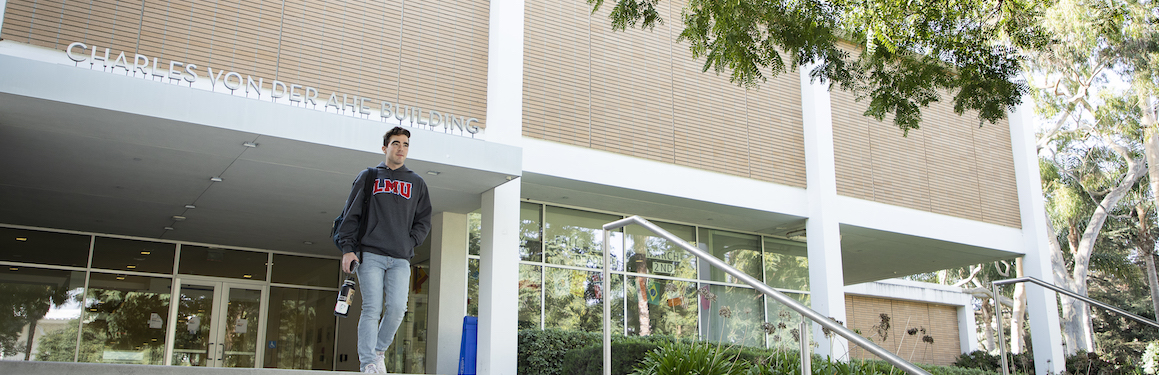 Student walking out of Charles Von der Ahe building.